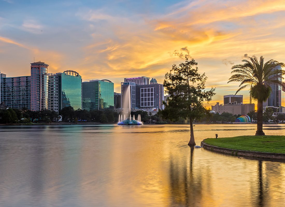 Contact - Orlando Skyline at Sunset, Water Reflecting the Orange and Pink Clouds